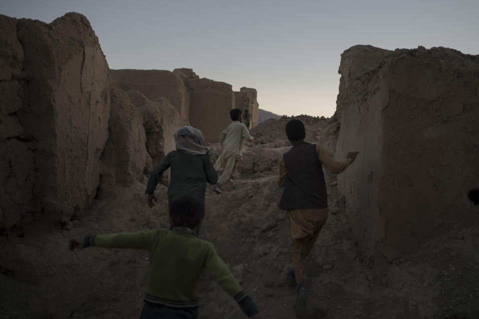 Afghan children play among the ruins of houses destroyed by war in Salar village, Wardak province, Afghanistan, Tuesday, Oct. 12, 2021.In urban centers, public discontent toward the Taliban is focused on threats to personal freedoms, including the rights of women. In Salar, these barely resonate. The ideological gap between the Taliban leadership and the rural conservative community is not wide. Many villagers supported the insurgency and celebrated the Aug. 15 fall of Kabul which consolidated Taliban control across the country. (AP Photo/Felipe Dana)