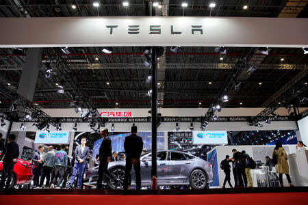 FILE PHOTO: People visit a Tesla booth during the media day for the Shanghai auto show in Shanghai, China April 16, 2019. REUTERS/Aly Song/File Photo