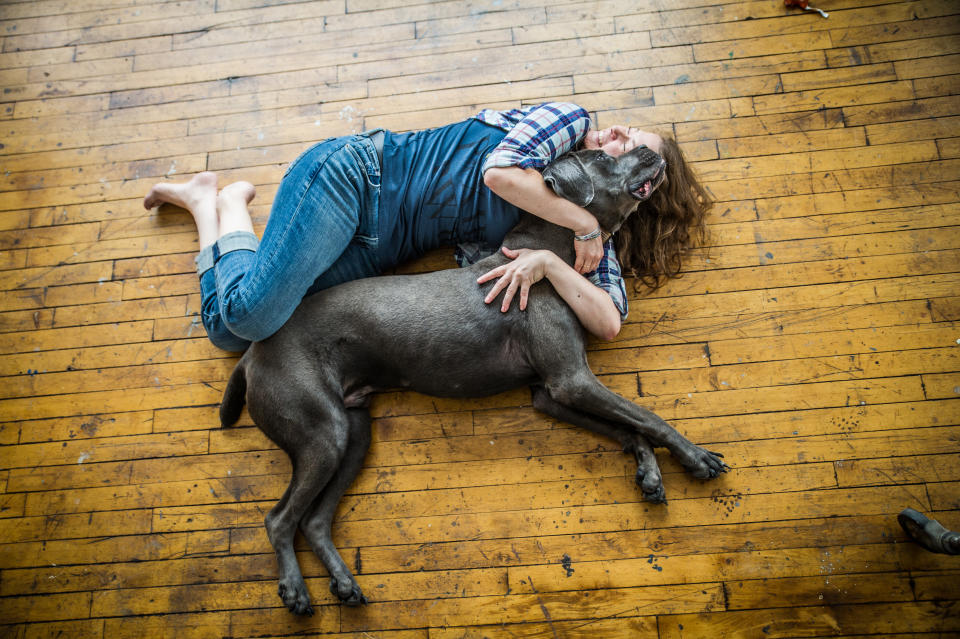 A woman cuddles a Great Dane. (Courtesy of Kristen Kidd Photography)