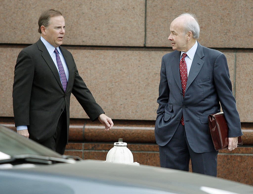 Former Enron CEO Jeff Skilling (L) greets former chairman Kenneth Lay (R) as they walk to the Bob Casey U.S. Courthouse for the third day of Skilling's testimony in their fraud and conspiracy trial April 12, 2006 in Houston, Texas.