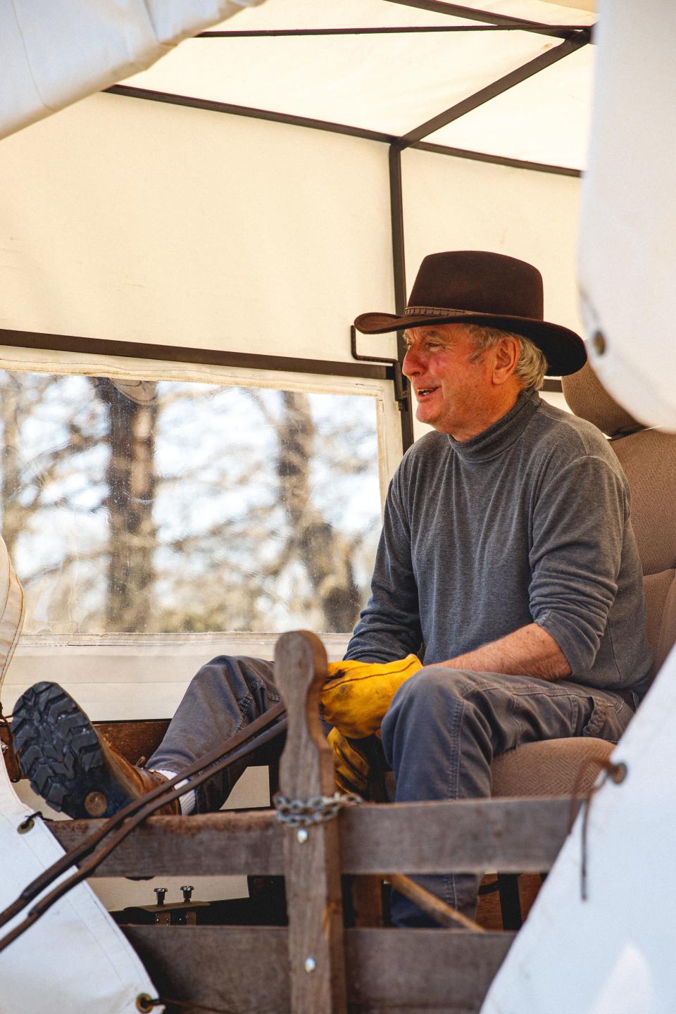 Phillip Brasfield laughs as he trots his mules through Maury County Park in Columbia, Tenn. on Mar. 29, 2023. Mule Day is an annual event in its 49th year that celebrates Columbia's history as a world-renowned mule trading post.