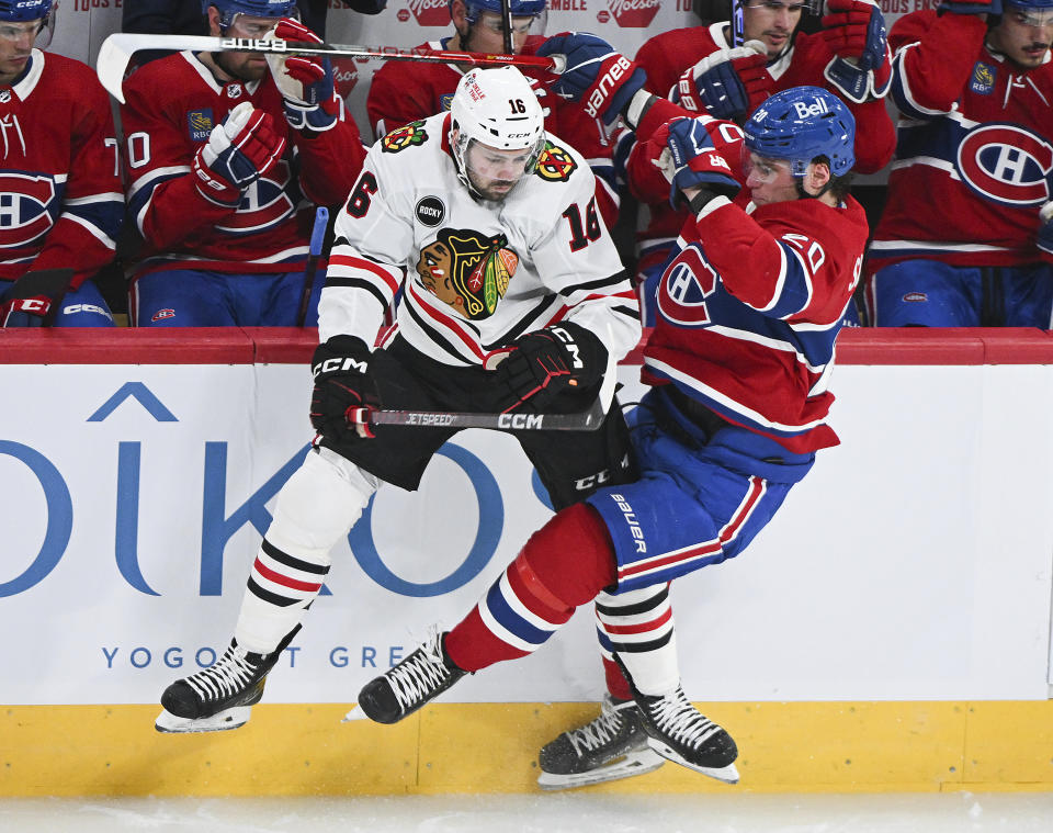 Montreal Canadiens' Juraj Slafkovsky (20) collides with Chicago Blackhawks' Jason Dickinson (16) during the first period of an NHL hockey game in Montreal, Saturday, Oct. 14, 2023. (Graham Hughes/The Canadian Press via AP)