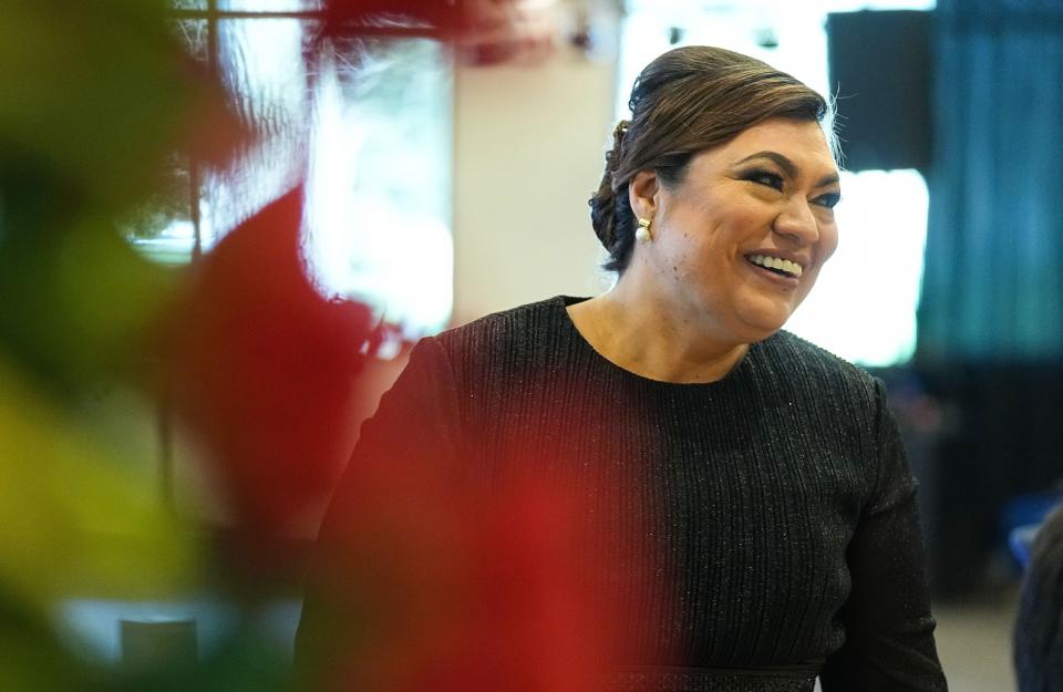 Emma Reyna, event decorator with Arik’s Event Decor smiles while talking to guests during her daughters quinceañera on Saturday, April 8, 2023 at Grand Hall in Indianapolis.
