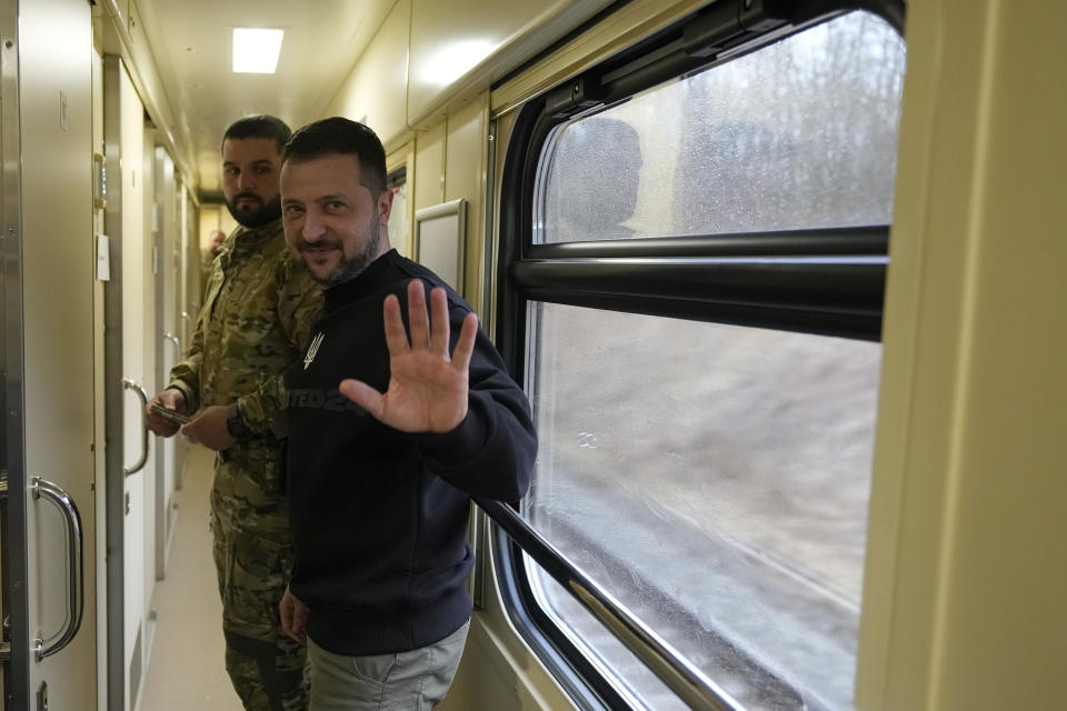 Ukrainian President Volodymyr Zelenskyy waves goodbye after an interview with The Associated Press on a train traveling from the Sumy region to Kyiv, Ukraine, Tuesday March 28, 2023. (AP Photo/Efrem Lukatsky)