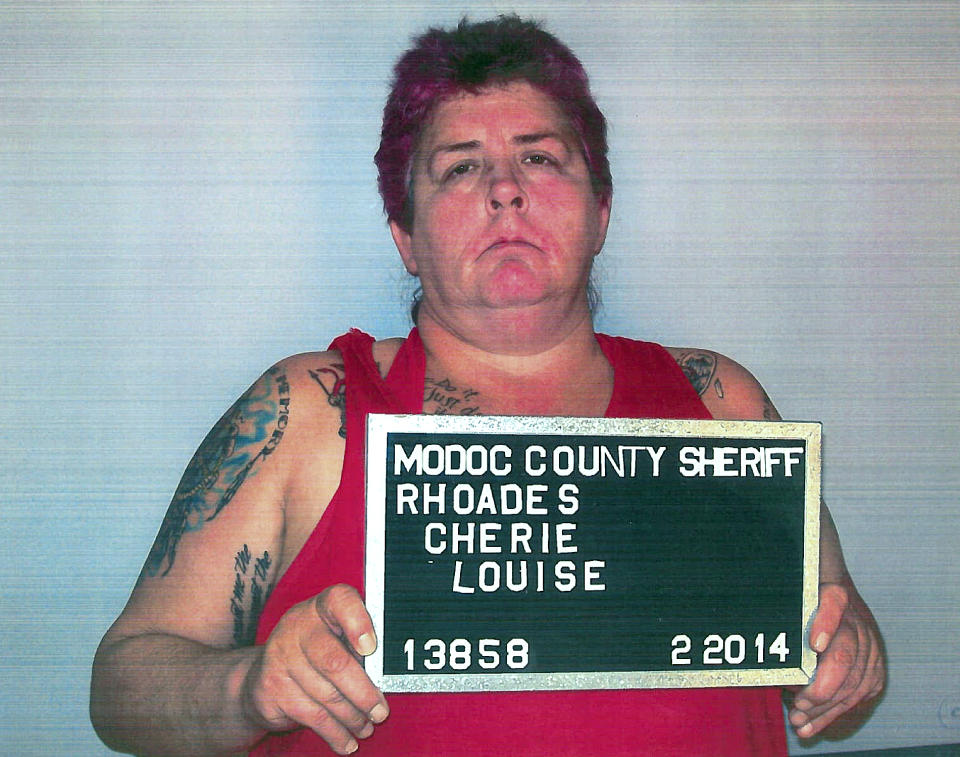 This Thursday, Feb. 20, 2014 photo released by Alturas Police Department shows Cherie Lash Rhoades. Rhoades, suspected of killing four people at the headquarters of an Indian tribe that was evicting her and her son from its land, had been under federal investigation over at least $50,000 in missing funds, a person familiar with the tribe's situation told The Associated Press on Friday. (AP Photo/Alturas Police Department)