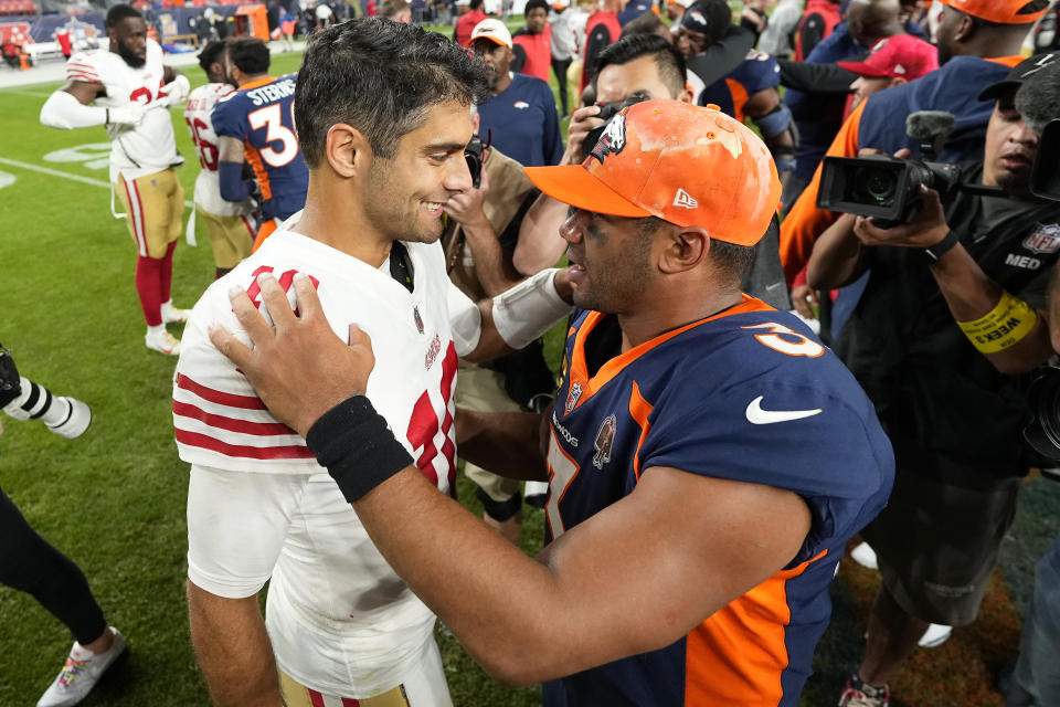 San Francisco 49ers quarterback Jimmy Garoppolo, left, talks with Denver Broncos quarterback Russell Wilson after an NFL football game in Denver, Sunday, Sept. 25, 2022. (AP Photo/Jack Dempsey)