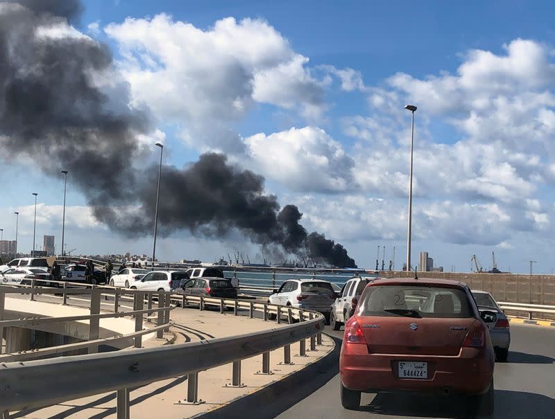 Smoke rises from a port of Tripoli after being attacked in Tripoli