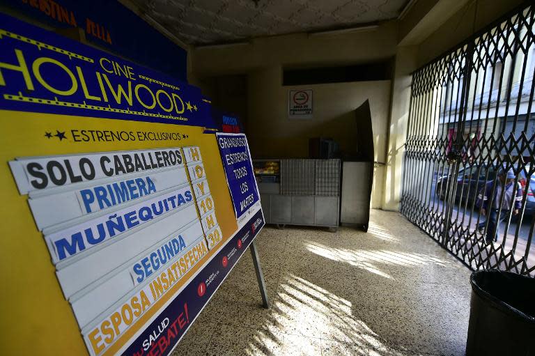 A board at the Hollywood porno cinema in Quito, advertises the latest movies as well as warning only men are allowed, on March 6, 2015