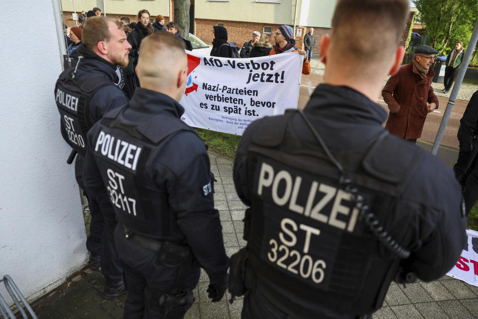 Police officers guard during a protest against German far-right politician of the Alternative for Germany Bjoern Hoecke, outside the state court in Halle, Germany, Thursday, April 18, 2024. Bjoern Hoecke, goes on trial at the state court in Halle on charges related to his alleged use in a 2021 speech of a slogan used by the Nazis' SA stormtroopers. (Fabrizio Bensch/Pool via AP)