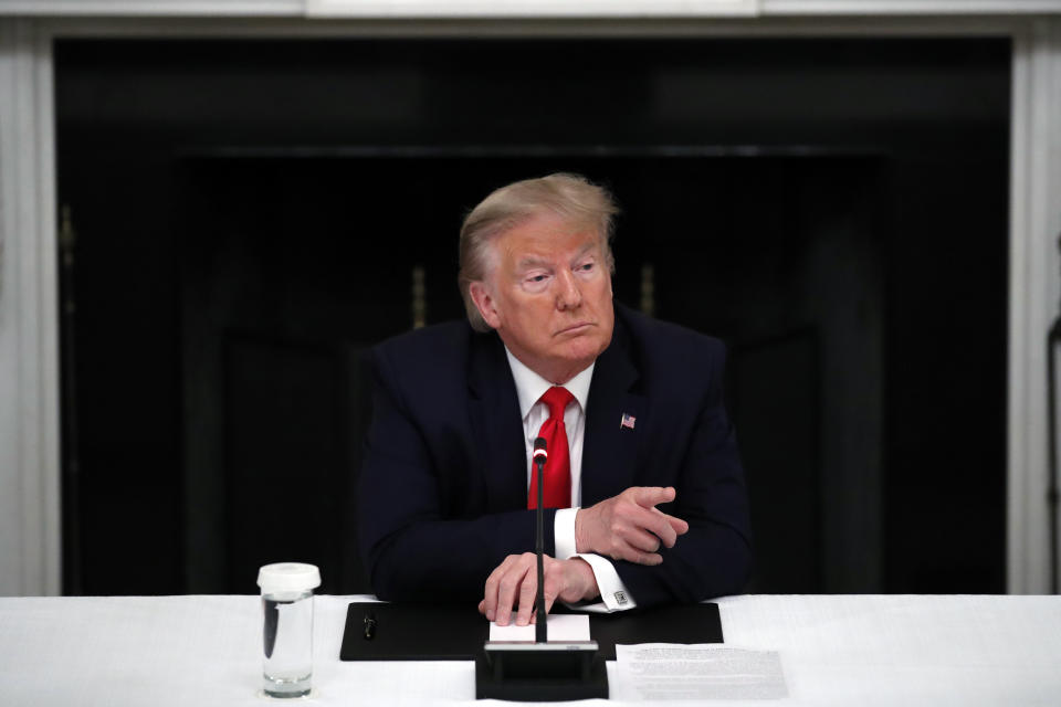 President Donald Trump listens during a roundtable with governors on the reopening of America's small businesses, in the State Dining Room of the White House, Thursday, June 18, 2020, in Washington. (AP Photo/Alex Brandon)
