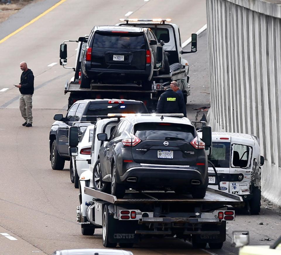 Cars are towed at the scene of a shooting Tuesday, Feb. 1, 2022, on Interstate 240 near the exit for Highway-385. A shooting suspect was taken to the hospital after firing at a Memphis police squad car. He then fled the scene and crashed his own car. 