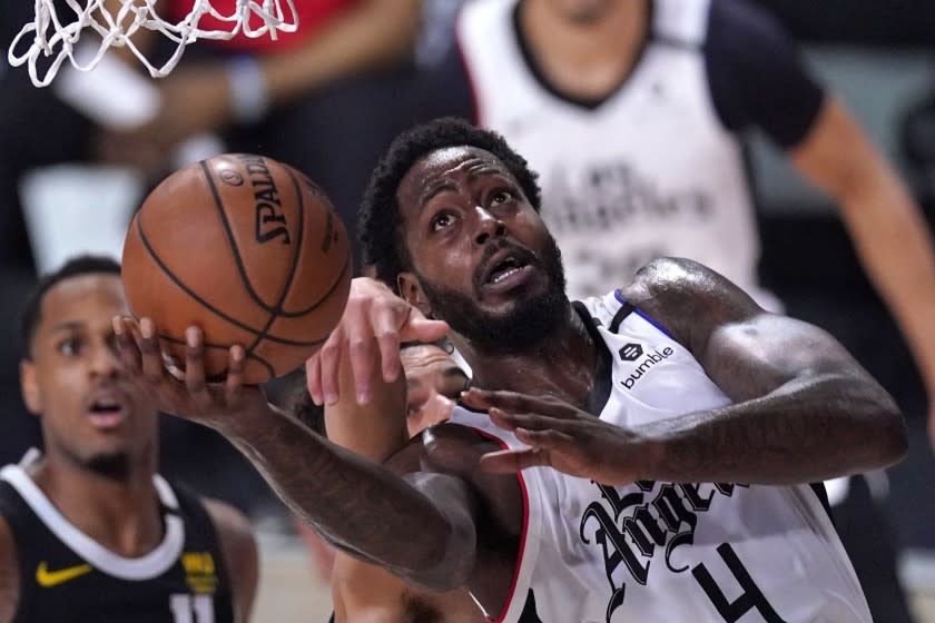 Los Angeles Clippers' JaMychal Green (4) goes up for a shot as Denver Nuggets' Michael Porter Jr. reaches in during the first half of an NBA conference semifinal playoff basketball game Sunday, Sept. 13, 2020, in Lake Buena Vista, Fla. (AP Photo/Mark J. Terrill)