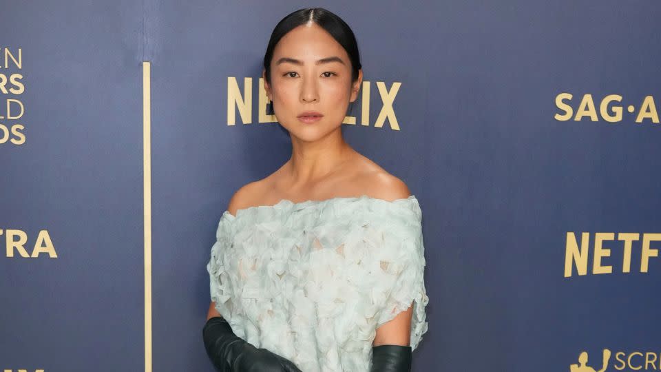 Greta Lee in a delicate sheath dress (and leather gloves) from The Row's 2024 Resort collection.. - Jordan Strauss/Invision/AP
