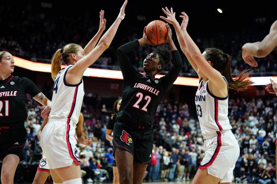 Dec 19, 2021; Uncasville, Connecticut, USA; Louisville Cardinals forward Liz Dixon (22) shoots the ball against UConn Huskies forward Dorka Juhasz (14) and guard Caroline Ducharme (33) in the second half at Mohegan Sun Arena. Mandatory Credit: David Butler II-USA TODAY Sports