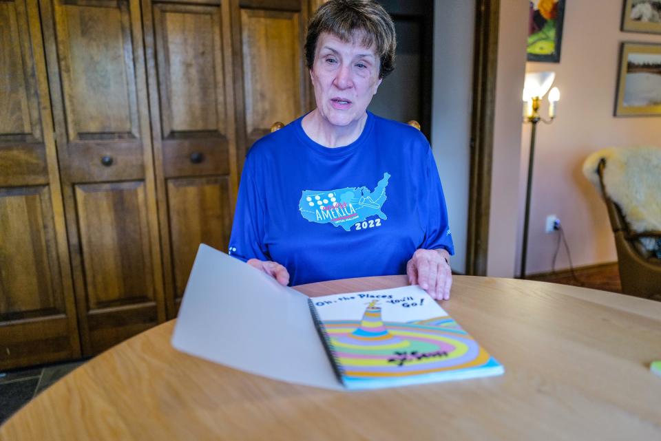 Okemos resident Rebekah Darnell, goes through a Dr. Seuss book that has been converted to Braille Sunday, April 16, 2023. She has read this book many times over the years to her son and others.