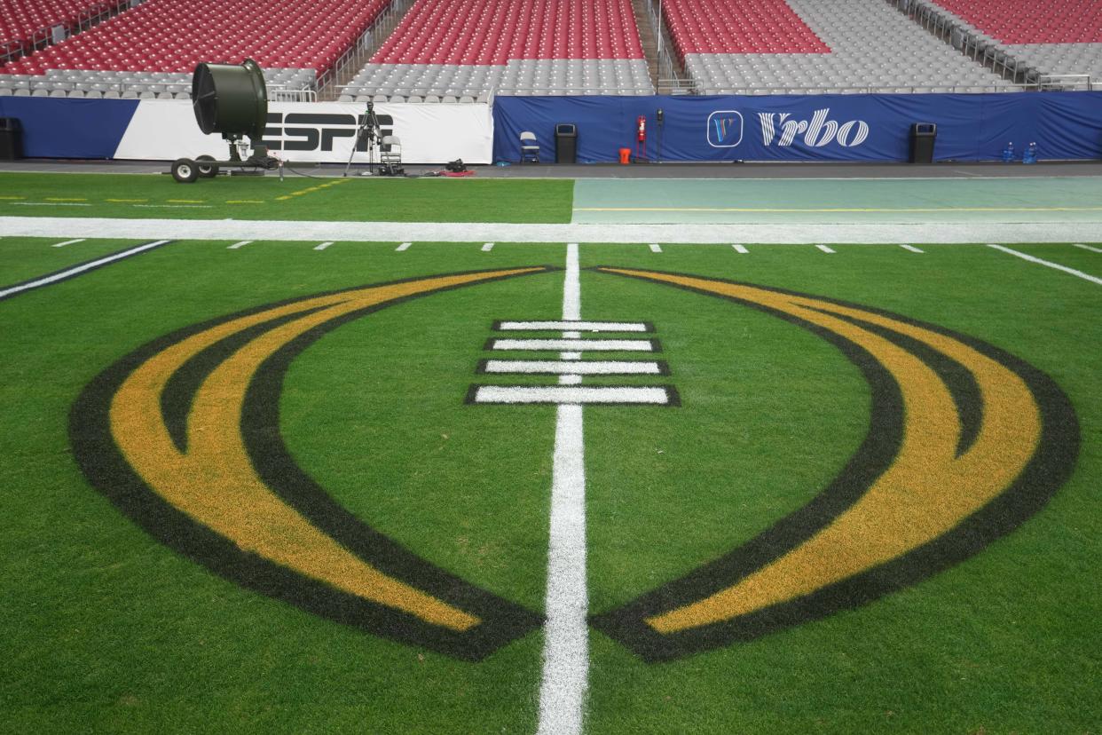 The College Football Playoff (CFP) logo on the field at the 2022 Fiesta Bowl at State Farm Stadium in Glendale on Dec. 31, 2022.