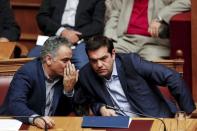 Greek Prime Minister Alexis Tsipras talks with Energy Minister Panos Skourletis (L) during a parliamentary session in Athens, Greece July 22, 2015. REUTERS/Yiannis Kourtoglou