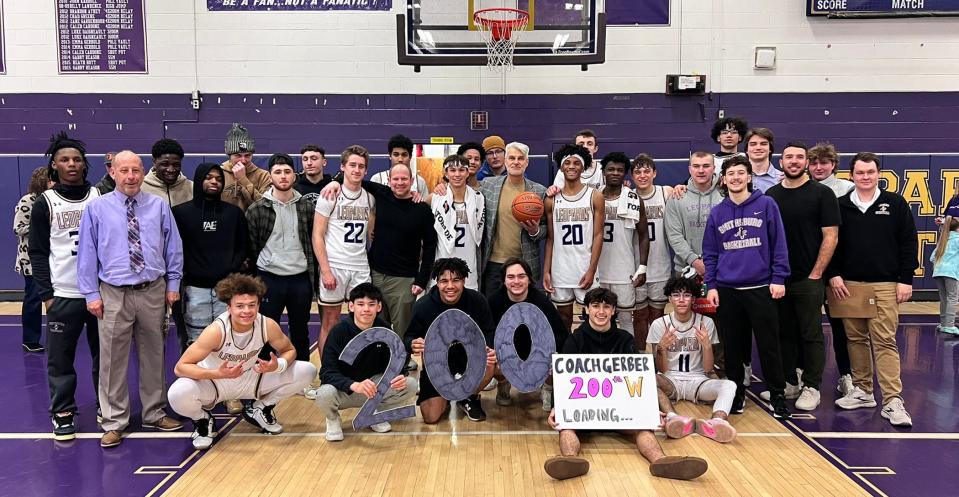 Eric Gerber, holding the game ball in the center, earned his 200th victory as Smithsburg's boys basketball head coach on Tuesday night, a 72-55 win over Brunswick.