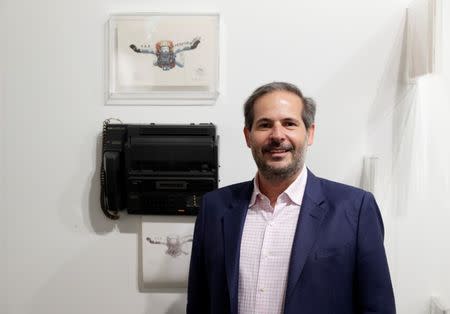 Alexandre Roesler, Partner and Senior Director of Galeria Nara Roesler, poses in front of "Fax performance" (1985) of Brazilian artist Paulo Bruscky during the Art Basel in Basel, Switzerland, June 13, 2018. REUTERS/Moritz Hager