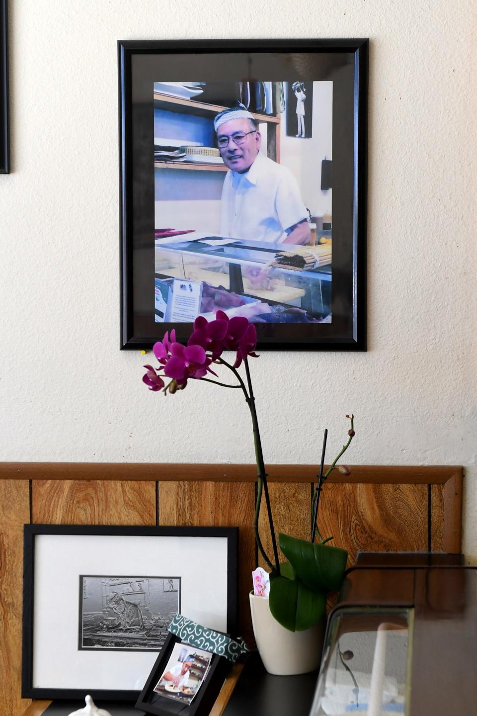 A photo of chef and restaurant owner Yuki Hanada, who passed away in late 2022, adorns a wall at Sushi Hanada on Wednesday, Nov. 1, 2023. After the passing of her husband in late 2022, owner Takako Hanada plans to retire.