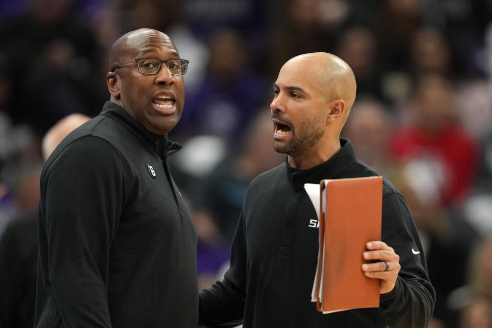 Mar 25, 2023; Sacramento, California, USA; Sacramento Kings head coach Mike Brown (left) and assistant coach Jordi Fernandez (right) talk during the fourth quarter against the Utah Jazz at Golden 1 Center. Mandatory Credit: Darren Yamashita-USA TODAY Sports