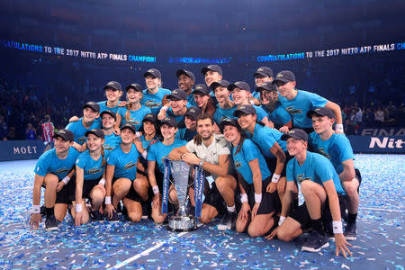 Tennis - ATP World Tour Finals - The O2 Arena, London, Britain - November 19, 2017 Bulgaria's Grigor Dimitrov celebrates with the trophy and ball girls and ball boys after winning the final against Belgium's David Goffin REUTERS/Toby Melville