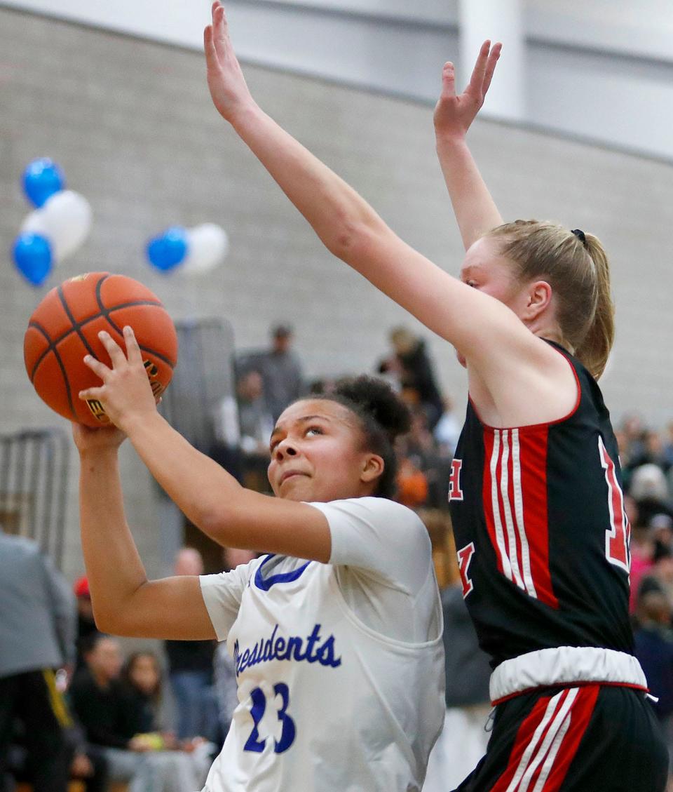 Senior captain Lena Waldron shoots under pressure from Bridget Capone of North Quincy.
Quincy High hosted North Quincy High in basketball. Both girls and boys teams played on Friday January 20, 2023.