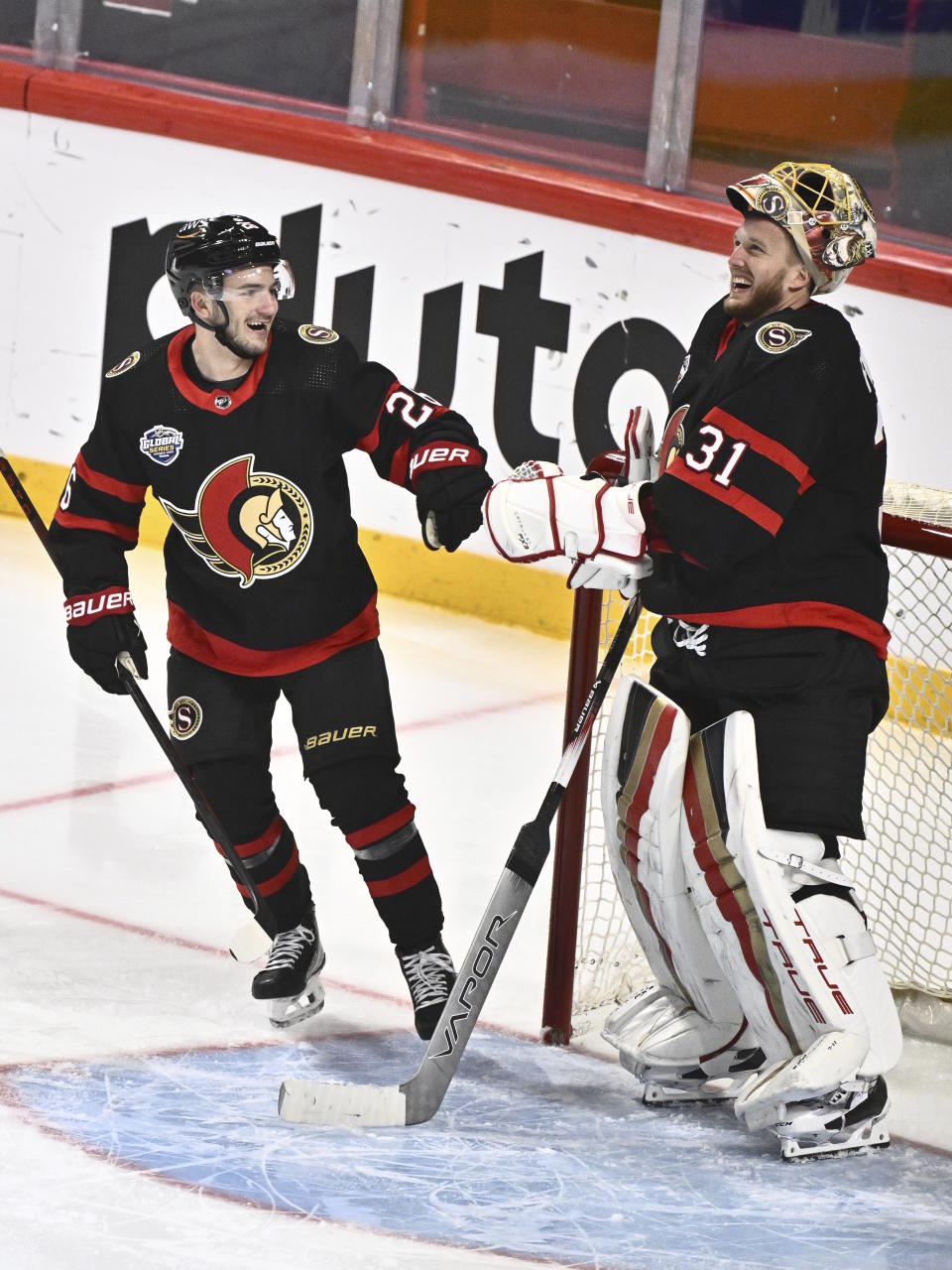 Ottawa's Erik Brannstrom, left, celbrates scoring with goalkeeper Anton Forsberg, right, who assisted during the NHL Global Series Sweden ice hockey match between Minnesota Wild and Ottawa Senators at Avicii Arena in Stockholm, Sweden, Saturday, Nov. 18, 2023. (Claudio Bresciani/TT News Agency via AP)