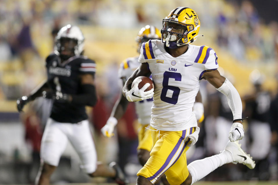 FILE - In this Saturday, Oct. 24, 2020 file photo, LSU wide receiver Terrace Marshall Jr. (6) runs the ball for a touchdown against South Carolina during the first half of an NCAA college football game in Baton Rouge, La. Baltimore ranked last in the NFL averaging 171.2 yards passing per game and had the fewest pass attempts with 406 last season. That’s partly because the running game was so proficient behind quarterback Lamar Jackson, the catalyst for the league’s No. 1 rushing attack (191.9 yards per game) for the second straight season.(AP Photo/Brett Duke, File)