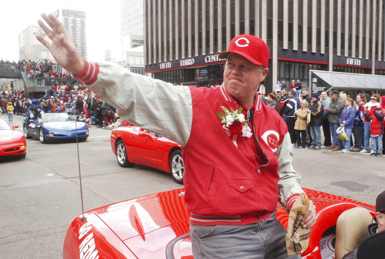 FILE - Former Cincinnati Reds pitcher Tom Browning waves during the Findlay Market Parade through downtown Cincinnati, March 31, 2003. Browning was grand marshall for the parade. Browning, an All-Star pitcher who threw the only perfect game in Cincinnati Reds history and helped them win a World Series title, died on Monday, Dec. 19, 2022. He was 62. (AP Photo/Tom Uhlman, File)