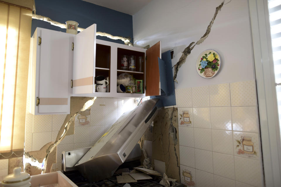 The house of William Mercuchi is damaged after the previous day's magnitude 6.4 earthquake in Yauco, Puerto Rico, Wednesday, Jan. 8, 2020. More than 250,000 Puerto Ricans remained without water on Wednesday and another half a million without power, which also affected telecommunications. (AP Photo/Carlos Giusti)