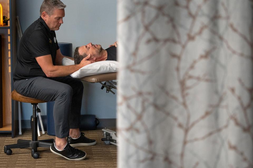 Bill Oesterle, right, works with Clinic Director Brian Stockman during a physical therapy session Wednesday, June 8, 2022 at Team Rehabilitation Physical Therapy. Oesterle has ALS, or amyotrophic lateral sclerosis, an incurable disease that affects parts of the nervous system, affecting muscle movement. It is also called Lou Gehrig's disease.