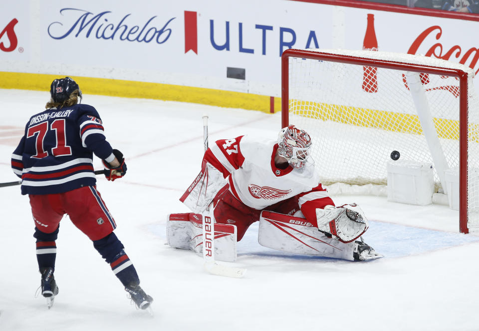Winnipeg Jets' Axel Jonsson-Fjallby (71) scores on Detroit Red Wings goaltender James Reimer during the second period of an NHL hockey game Wednesday, Dec. 20, 2023, in Winnipeg, Manitoba. (John Woods/The Canadian Press via AP)