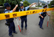 <p>Police officers investigate near a facility for the disabled, where a deadly attack by a knife-wielding man took place, in Sagamihara, Kanagawa prefecture, Japan, July 26, 2016. (REUTERS/Issei Kato)</p>