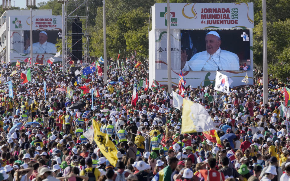 Worshipers gather as they wait for Pope Francis arriving at Lisbon's Parque Eduardo VII to preside over a 'Via Crucis' (Way of the Cross) with young people participating into Sunday's 37th World Youth Day in the Portuguese capital, Friday, Aug. 4, 2023. Francis is in Portugal through the weekend to preside over the jamboree that St. John Paul II launched in the 1980s to encourage young Catholics in their faith. (AP Photo/Armando Franca)