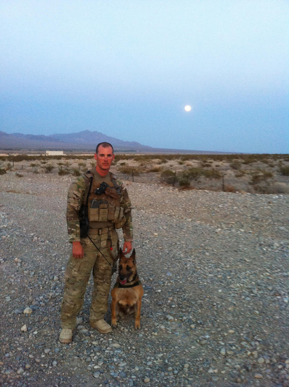 This 2012 publicity photo provided by Animal Planet shows pre-deployment photos of Air Force Tech. Sgt. Leonard Anderson and a bomb-detecting dog, Azza, an 8-year-old Belgian Malinois at training in Las Vegas. After the Nevada training, Air Force Tech. Sgt. Anderson and Azza were sent to Kandahar Province, in Afghanistan. Animal Planet television special "Glory Hounds," included coverage of Air Force Tech. Sgt. Anderson, a military dog handler and his team, when they embedded four camera crews with front line troops for six weeks. (AP Photo/Animal Planet)