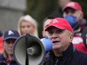 Serbia's Novak Djokovic's father Srdjan speaks during a protest in Belgrade, Serbia, Thursday, Jan. 6, 2022. Djokovic's father Srdjan said he was the victim of a "political agenda" in Australia. The Australian government has denied No. 1-ranked Novak Djokovic entry to defend his title in the year's first tennis major and canceled his visa because he failed to meet the requirements for an exemption to the country's COVID-19 vaccination rules. (AP Photo/Darko Vojinovic)