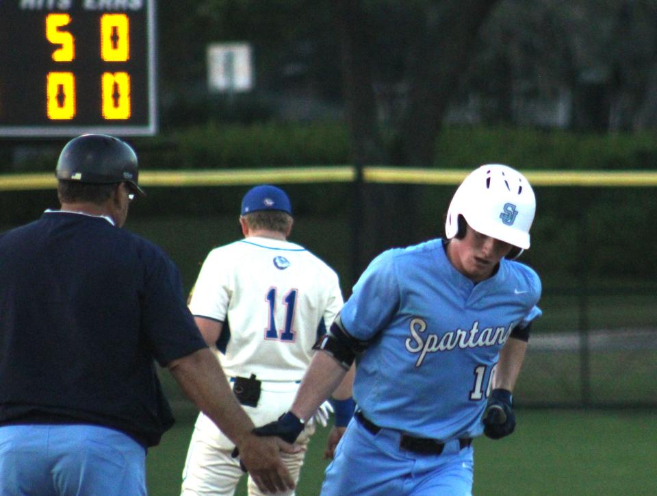 St. Johns Country Day's Bradley Hodges (10) is congratulated by head coach Tom Lucas after hitting a home run against Bolles during a high school baseball game on March 16, 2022. [Clayton Freeman/Florida Times-Union]