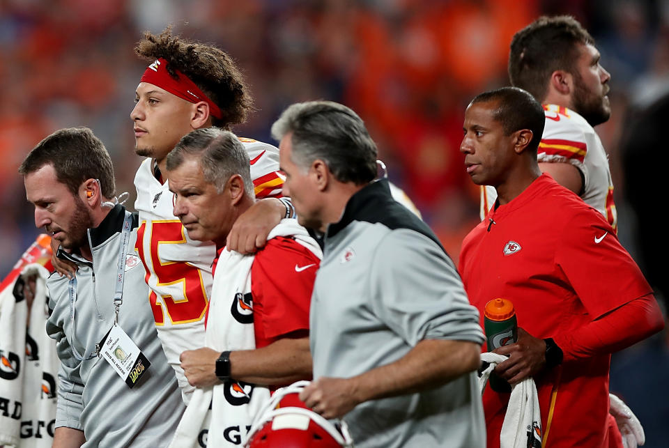 DENVER, COLORADO - OCTOBER 17: Quarterback Patrick Mahomes #15 of the Kansas City Chiefs is escorted off the field after an injury on the first half against the Denver Broncos  in the game at Broncos Stadium at Mile High on October 17, 2019 in Denver, Colorado. (Photo by Matthew Stockman/Getty Images)