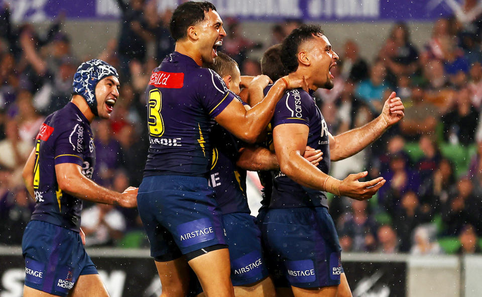The Melbourne Storm, pictured here celebrating after Nick Meaney's try against the Warriors.