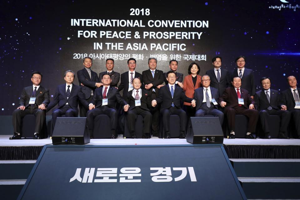 North Korean Ri Jong Hyok, fourth from left, vice chairman of the Korean Asia-Pacific Peace Committee poses with Lee Jae-myung, fifth from right, Gyeonggi province governor and Hatoyama Yukio, second from left, former Japanese Prime Minister attend for group photo during the international convention for peace and prosperity in the Asia-Pacific Friday, Nov. 16, 2018 in Goyang, South Korea. (Chung Sung-Jun/Pool Photo via AP)