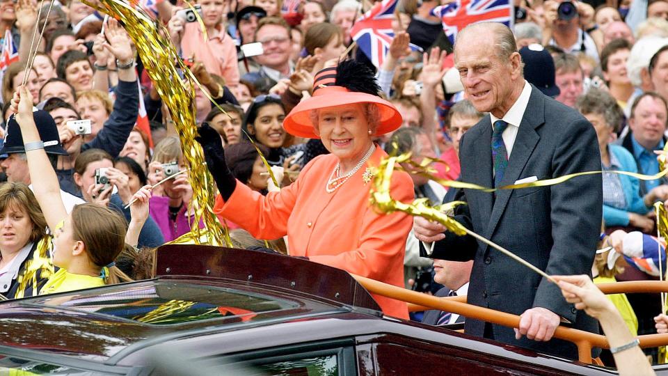 Queen Elizabeth II and Prince Phillip the Duke of Edinburgh ride along the Mall in an open top car on their way to watch a parade in celebration of the Golden Jubilee on June 4, 2002