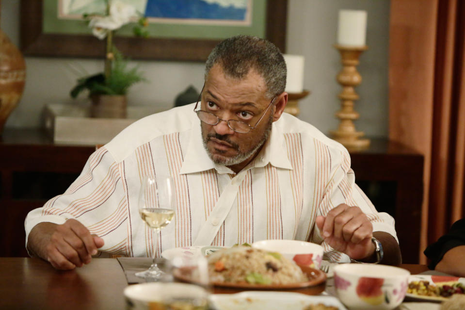 Laurence Fishburne at a dinner table in black-ish