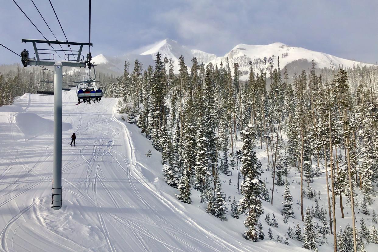 skiers on ski lift in Big Sky, Montana