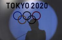 A shadow of of Tokyo governor Yuriko Koike is seen on the logo of Tokyo 2020 Olympic games during the Olympic and Paralympic flag-raising ceremony at Tokyo Metropolitan Government Building in Tokyo, Japan, September 21, 2016. REUTERS/Toru Hanai