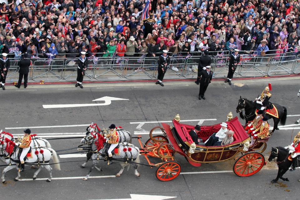 Britain's Queen E;izabeth in carriage 2nd right, sits with Rrince Charles and Camilla Duchess of Cornwall, as they head for Buckingham Palace in a carriage procession in London Tuesday June 5, 2012. The carriage procession is part of a four-day Diamond Jubilee celebration to markthe 60th anniversary of Queen Elizabeth II accession to the throne (AP Photo/Elizabeth Dalziel/Pool)