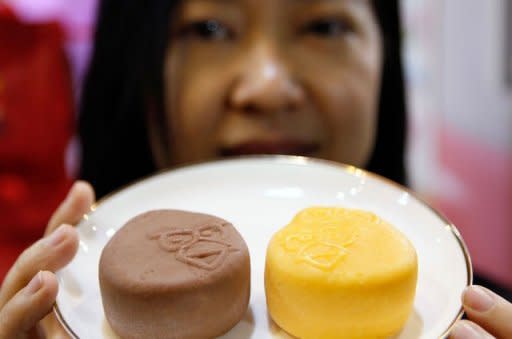 An employee displays the newly launched 'Angry Birds' mooncakes, a popular Chinese baked pastry made from lotus seed paste and salted egg yolks available this time of the year, during the Hong Kong Food Expo on August 14. The pastries are named after the popular mobile game