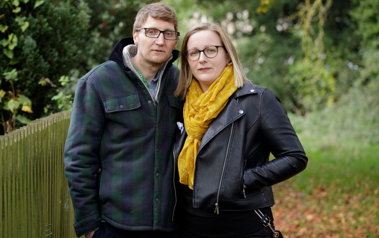 A man who had a brain haemorrhage after the covid vaccine stands next to his wife on a country path