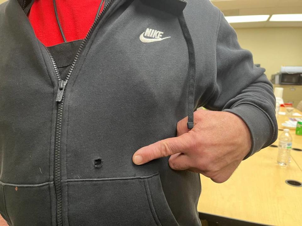 Ron Rios has been wearing his son’s hoodie to work since late December, when Brandon Rios was shot at the Belleville MetroLink station, to remind him how lucky he was to survive. Ron is pointing to one of three bullet holes.