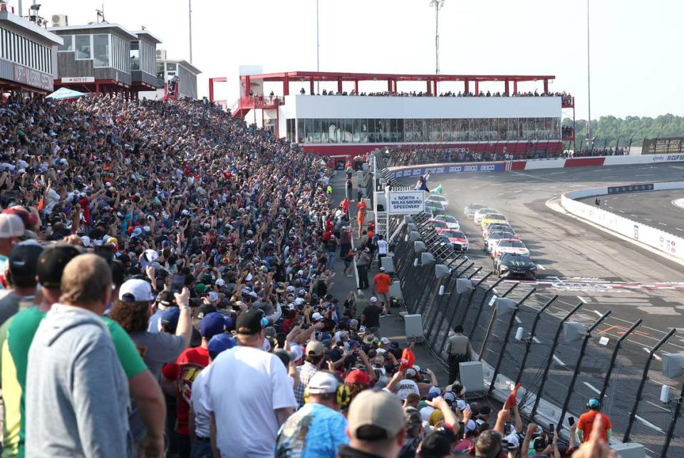 NASCAR fans cheer as drivers cross the start line to begin the All-Star Open race at North Wilkesboro Speedway on Sunday, May 21, 2023.